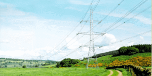 Pylon in a bright green spring field.