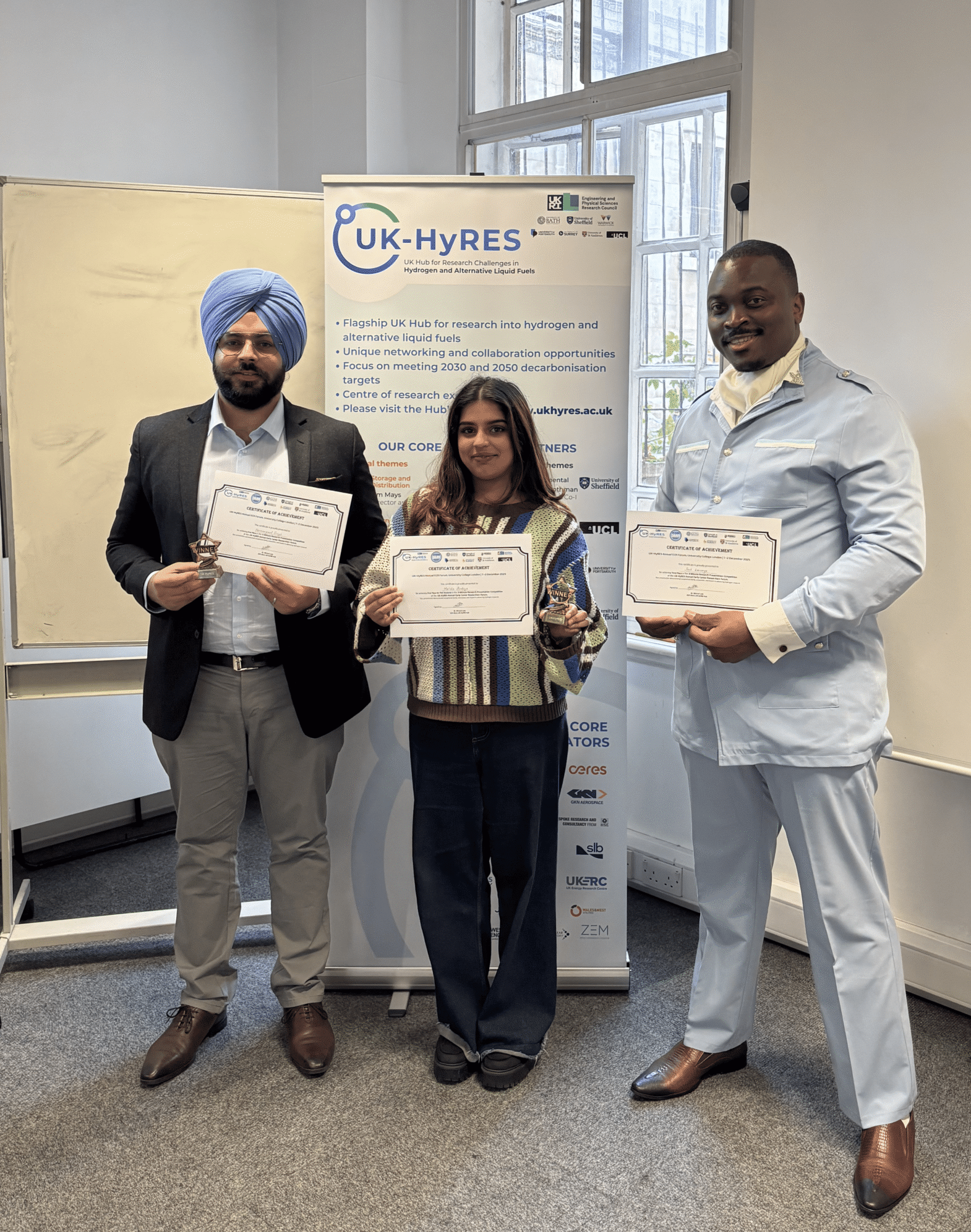 Three ECR's holding certificates and awards at a Annual Forum